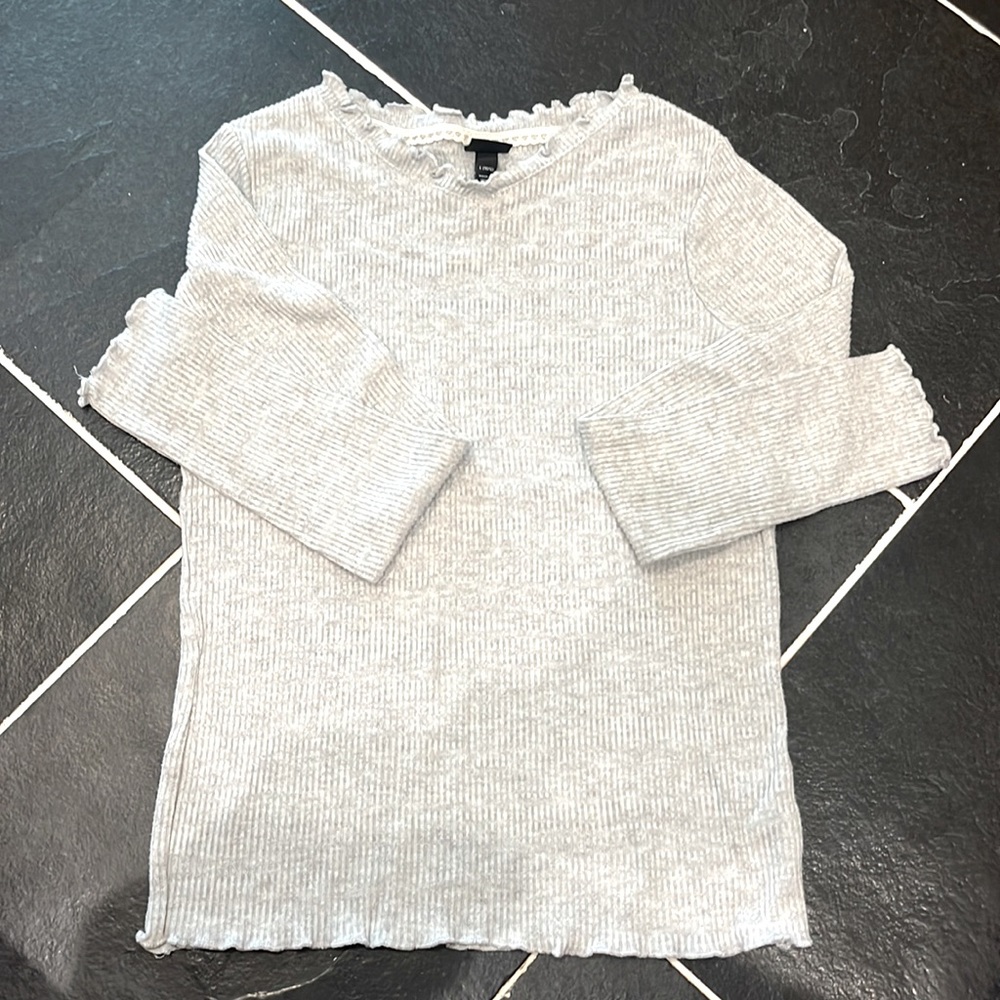 Thin long sleeve heather gray shirt w/ small ruffles around collar and sleeves.